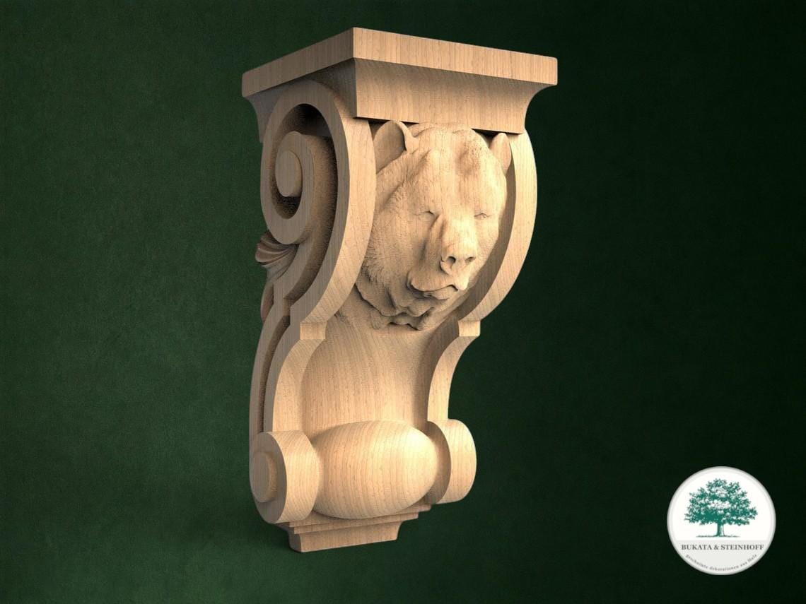 a carved wooden sculpture of a bear's head, mounted on a green wall.