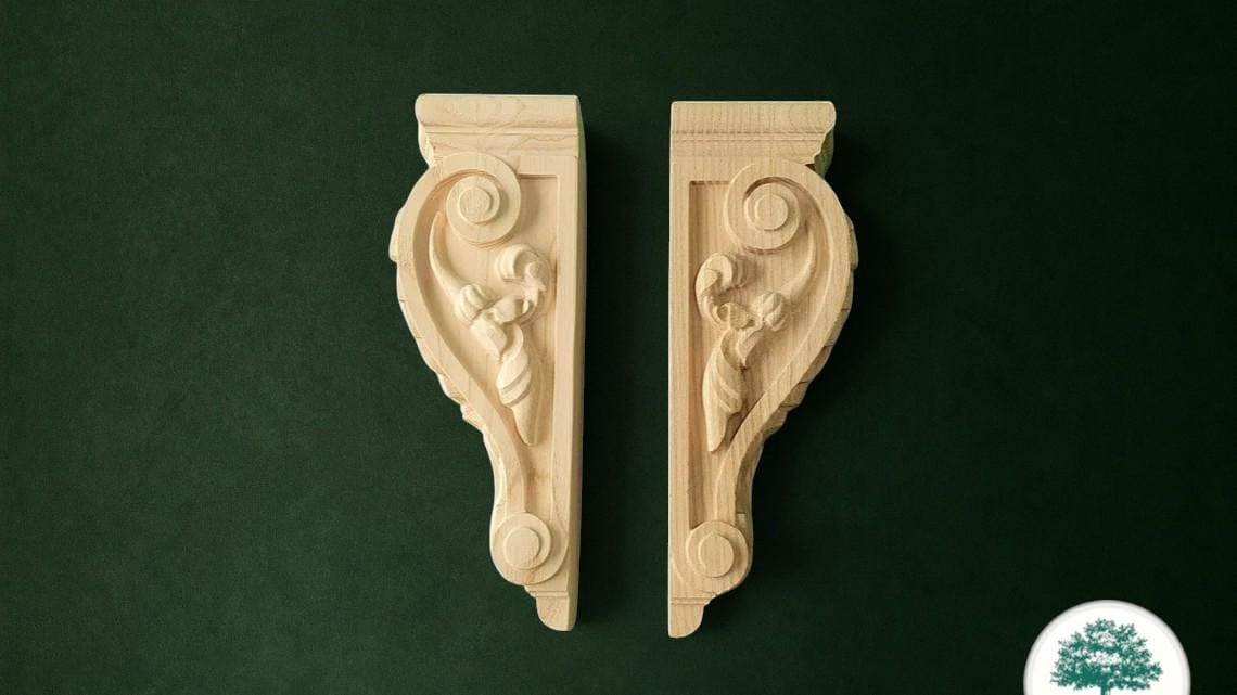 two intricately carved wooden brackets against a dark green background.