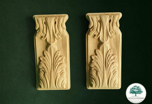 two intricately carved wooden pieces, each with a unique design, set against a dark green background.
