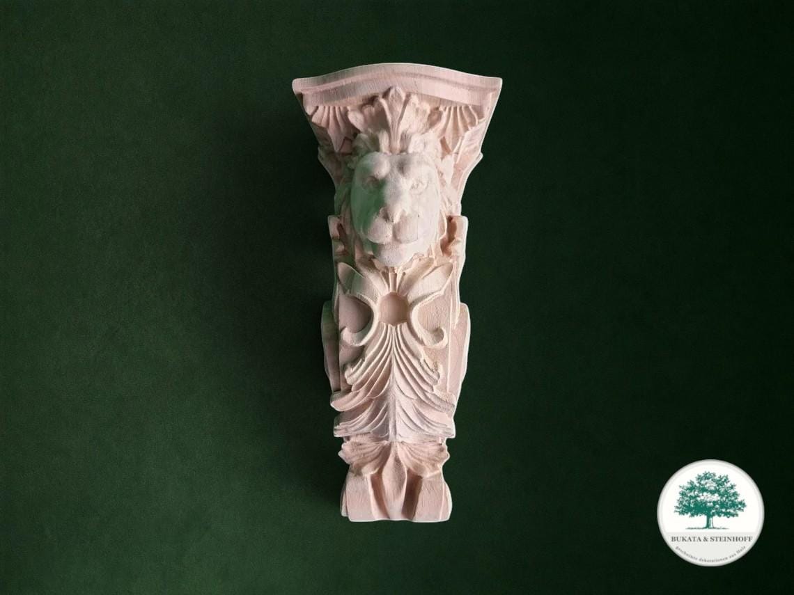 a decorative lion sculpture against a dark green background.