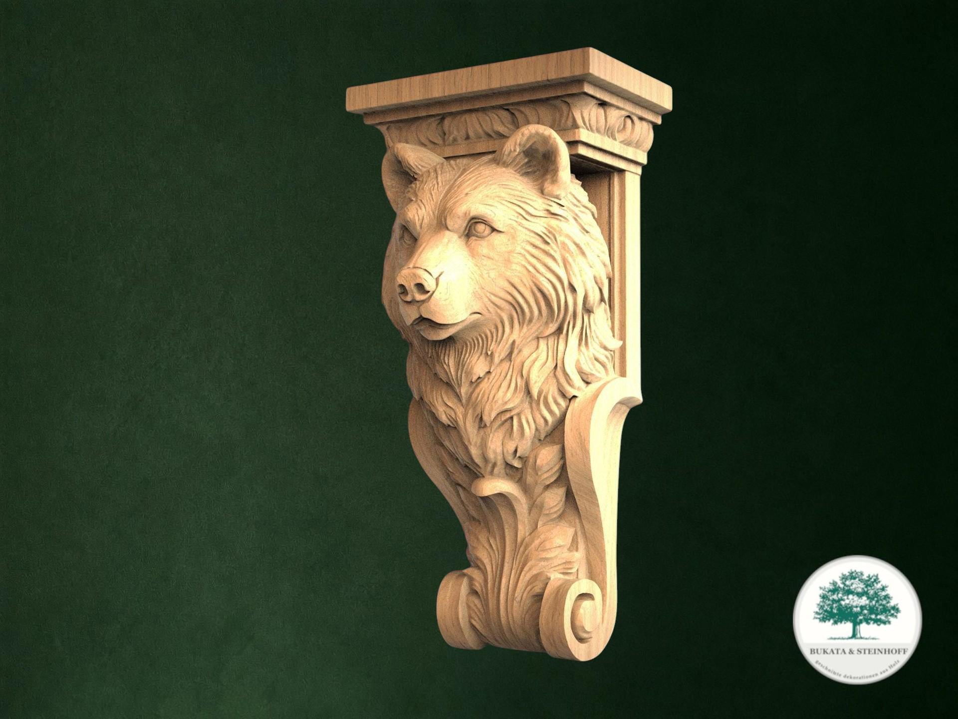 A carved wooden bear head is displayed against a dark green background.