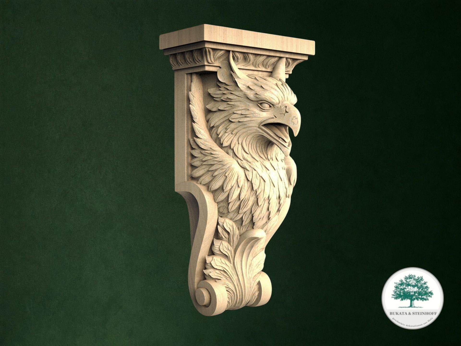 A carved wooden eagle head with wings and a tail, mounted on a wooden post against a dark green background.
