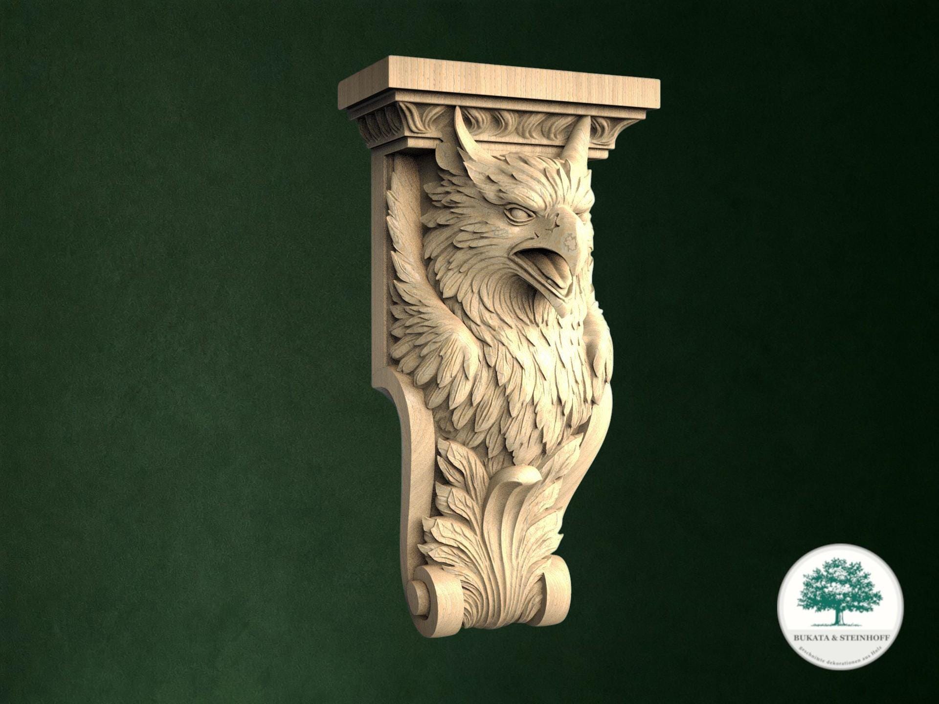 A carved wooden eagle or owl-like sculpture is displayed against a dark green background.