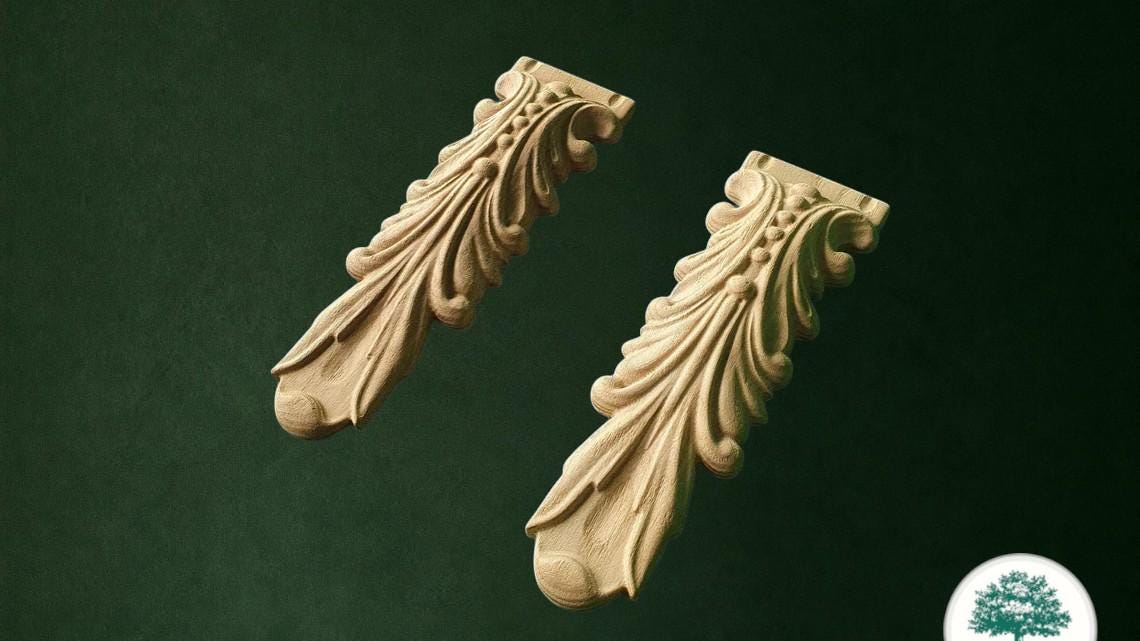 two ornate wooden carvings with intricate designs, set against a dark green background.