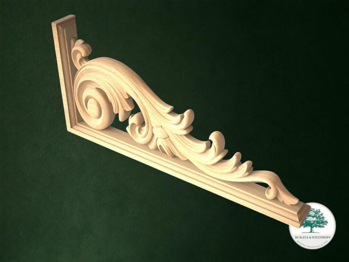 A decorative wooden bracket with an ornate scrollwork design, displayed against a dark green background.