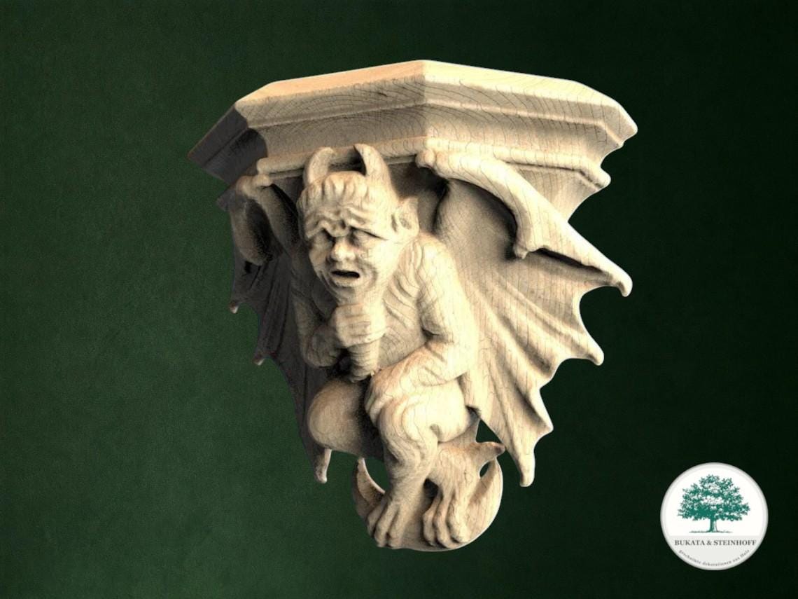 A carved wooden gargoyle figure with wings and horns, set against a dark green background.