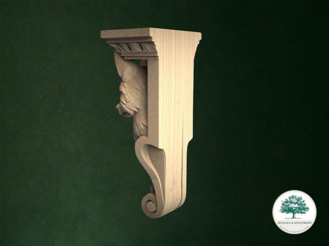 A wooden carving of a lion's head is displayed against a dark green background.