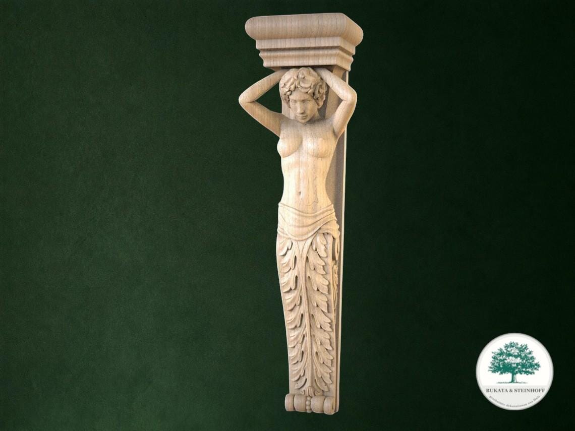 A carved wooden statue of a woman with her arms raised, standing on a pedestal.