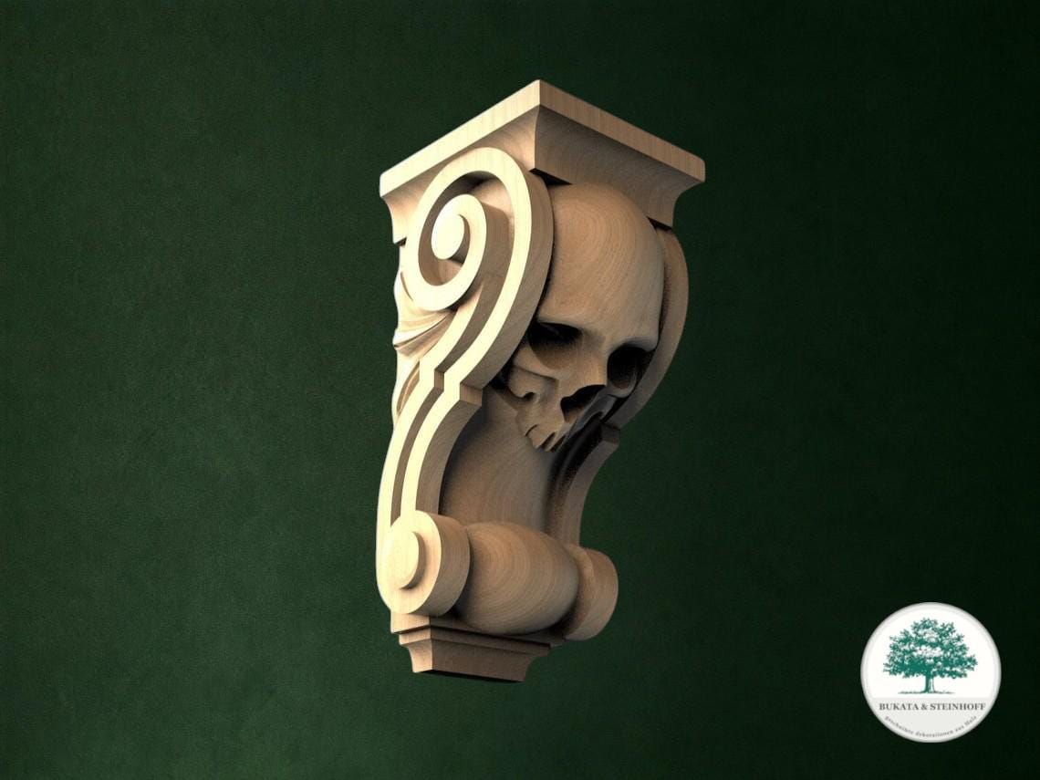 A carved wooden sculpture of a skull with an ornate scroll design on a dark green background.