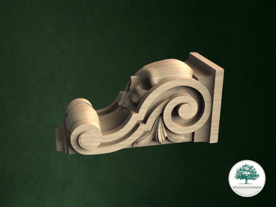 A wooden carving of a stylized skull on a dark green background.