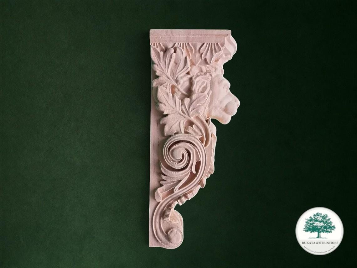 a decorative piece of wood with an intricate floral design carved into it, set against a dark green background.