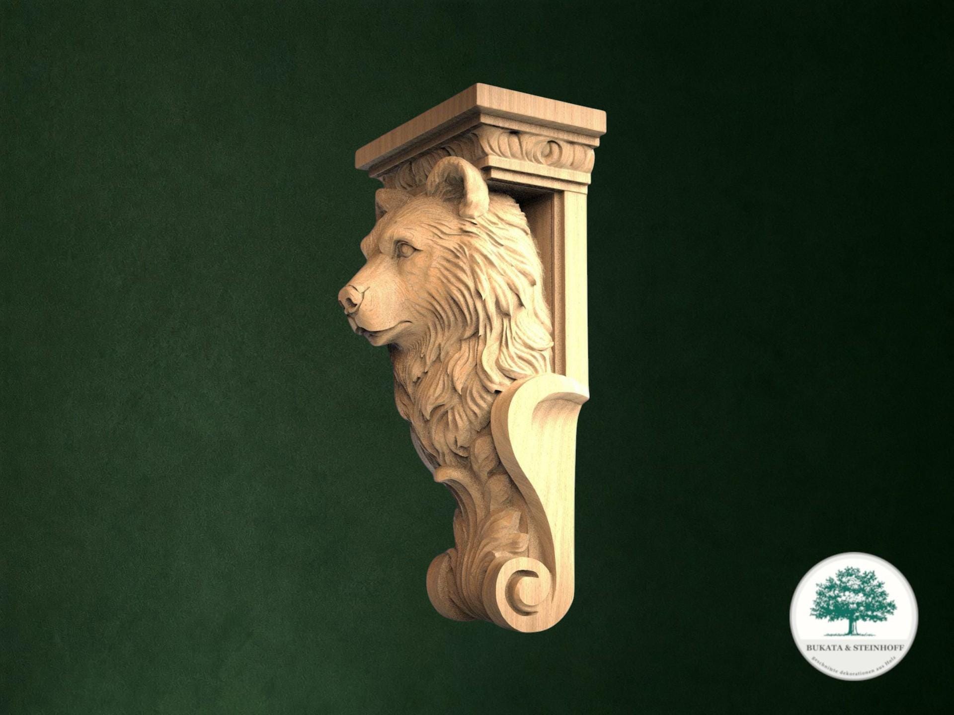 A carved wooden bear head mounted on a green wall.