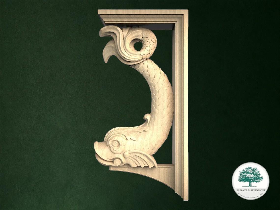 A carved wooden fish-shaped bracket is displayed against a dark green background.