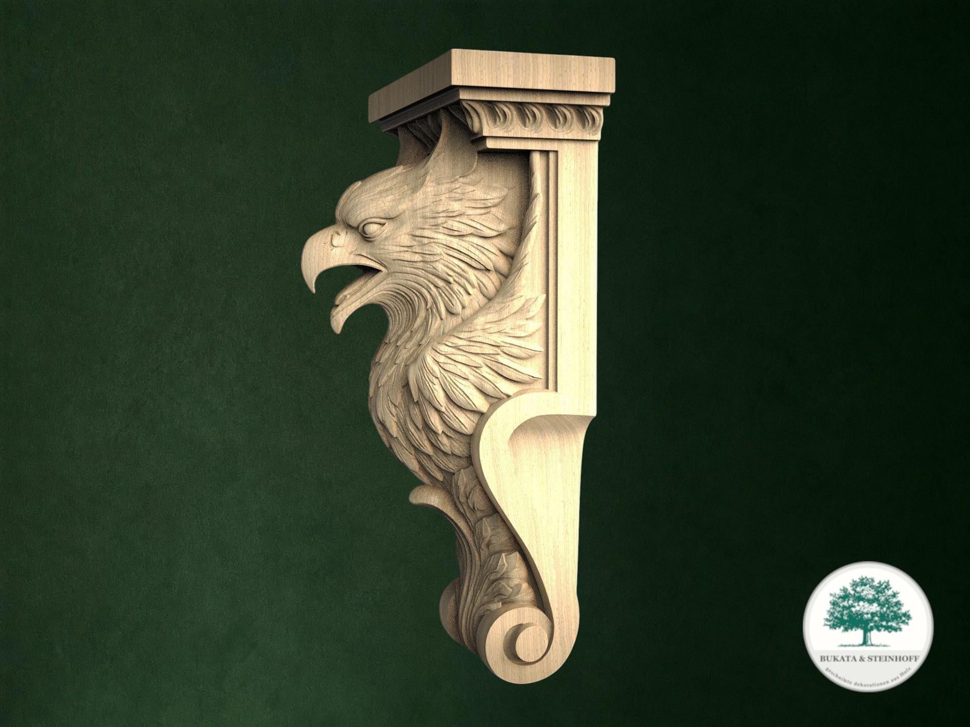 A carved wooden eagle or phoenix-like figure with a carved head and wings, mounted on a wooden post or bracket against a dark green background.
