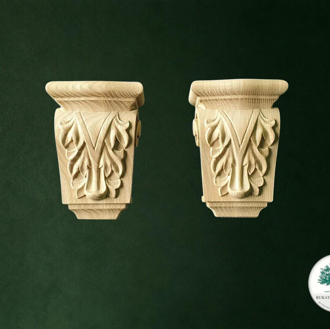 Two ornate wooden shelves with carved leaf designs on them, set against a dark green background.