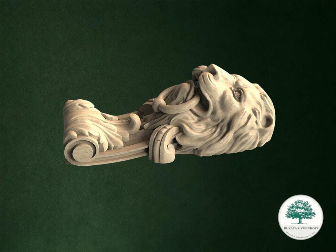 A carved wooden lion head with a scroll-like design on its neck and head, set against a dark green background.