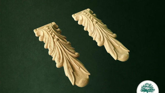two ornate wooden carvings with intricate designs, set against a dark green background.