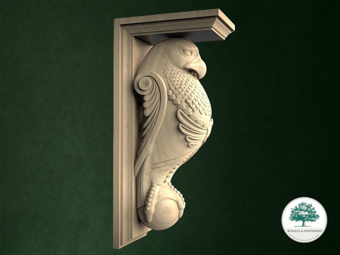 A carved wooden bird-like figure is mounted on a wall, with a green background.