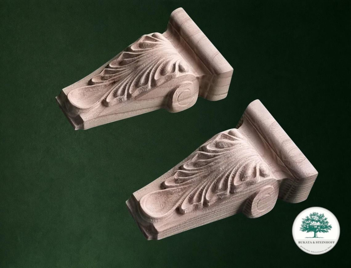 two intricately carved wooden pieces with a dark green background.