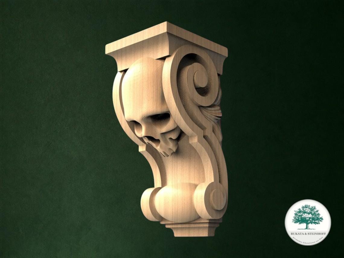 A carved wooden sculpture of a skull with a scroll-like design on a dark green background.